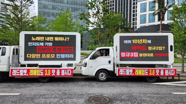 Red Velvet fans send protest vehicles to SM for lack of albums